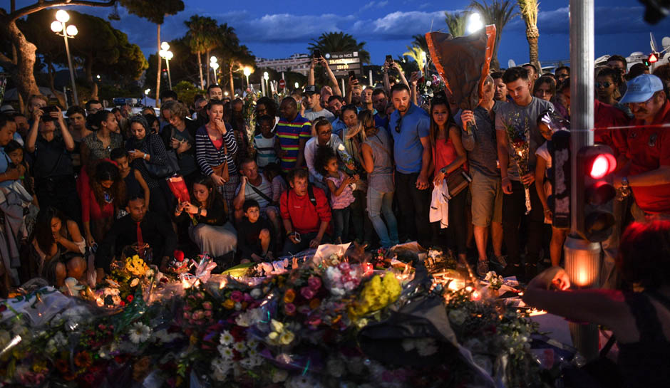 NICE, FRANCE - JULY 15:  People visit the scene and lay tributes to the victims of a terror attack on the Promenade des Anglais on July 15, 2016 in Nice, France. A French-Tunisian attacker killed 84 people as he drove a lorry through crowds, gathered to watch a firework display during Bastille Day Celebrations. The attacker then opened fire on people in the crowd before being shot dead by police.  (Photo by David Ramos/Getty Images)