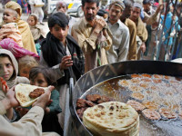 Pakistani poor people get free food from a restaurant in Rawalpindi, Pakistan on Monday, April 7, 2008. According to the World Food Programme (WFP) survey nearly half of Pakistan s 160 million people are at the risk of facing food shortage due to an increase in food prices. The WFP survey shows that the number of people who are  food insecure  has risen 28 percent to 77 million from 60 million last year. (AP Photo/Anjum Naveed)