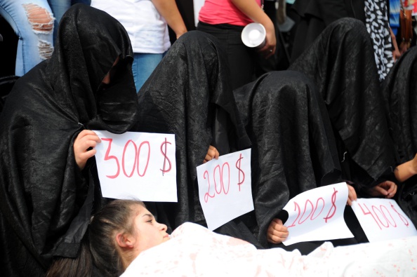 BRUSSELS, BELGIUM - SEPTEMBER 8:  Yezidi women hold signs during demonstration against the attacks of Islamic State (IS) in Iraq in front of the European Parliament at the Luxembourg square in Brussels, Belgium on September 8, 2014. (Photo by Dursun Aydemir/Anadolu Agency/Getty Images)