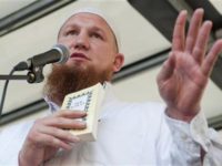 Islamic cleric Pierre Vogel gestures as he delivers his speech during a pro-Islam demonstration in Hamburg July 9, 2011. The book he is holding is a German edition of the Koran. REUTERS/Morris Mac Matzen