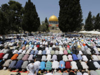 The Dome of Rock is seen in the background as Palestinian men pray on the compound known to Muslims as Noble Sanctuary and to Jews as Temple Mount in Jerusalem's Old City, on the first Friday of the holy month of Ramadan July 12, 2013. Israeli police said that Palestinian males over the age of 40 would be freely permitted to enter the compound in Jerusalem's Old City on Friday. REUTERS/Ammar Awad (JERUSALEM - Tags: RELIGION)