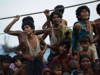 Rohingya migrants stand and sit on a boat drifting in Thai waters off the southern island of Koh Lipe in the Andaman sea on May 14, 2015.  The boat crammed with scores of Rohingya migrants -- including many young children -- was found drifting in Thai waters on May 14, according to an AFP reporter at the scene, with passengers saying several people had died over the last few days.     AFP PHOTO / Christophe ARCHAMBAULTCHRISTOPHE ARCHAMBAULT/AFP/Getty Images
