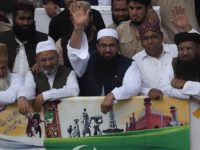 Hafiz Saeed, center, head of a religous group Jamaat-ud-Dawa waves to supporters while he with other leaders leads a rally to mark Pakistan Independence Day in Karachi, Pakistan on Sunday, Aug. 14, 2016. The Pakistani nation is celebrating its 70th Independence Day, to mark its independence from the British rule in 1947. (AP Photo/Shakil Adil)