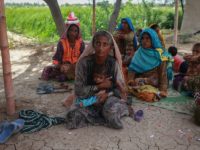 Muradi hold her eighteenth child as she wait for a checkup at the mobile clinic set up at Sikandarabad, district Naseerabad in Balochistan province, Pakistan