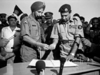 EAST PAKISTAN. Dacca. December 16, 1971. City Stadium. Indian General Jagjit Singh AURORA (left) hands a pen to Pakistani General Amir Abdullah Khan NIAZI, Governor of East Pakistan, to sign the document surrendering his army.