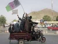 Kabul: Taliban fighters and their supporters carry a representation of the Afghan national flag and a Taliban flag while riding in a motorized vehicle, in Kabul, Afghanistan, Sunday, June 17, 2018. A suicide bomber struck Sunday in Afghanistan's eastern city of Jalalabad, killing at least 18 people in the second attack in as many days targeting Taliban fighters, security forces and civilians celebrating a holiday cease-fire. AP/PTI(AP6_17_2018_000142B)
